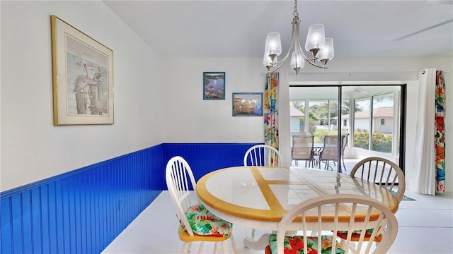 tiled dining space featuring a notable chandelier