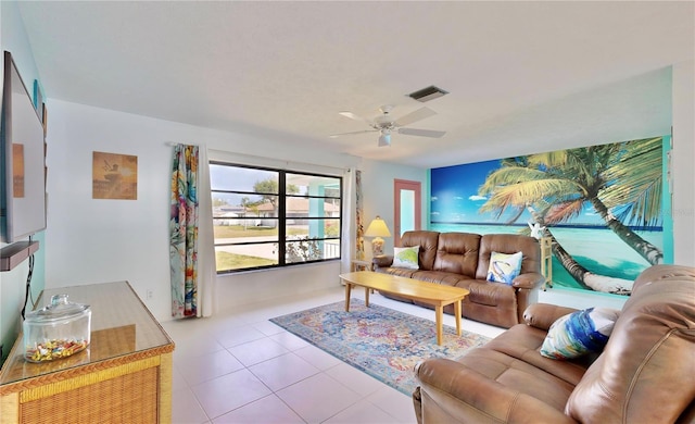 living room with ceiling fan and light tile patterned flooring