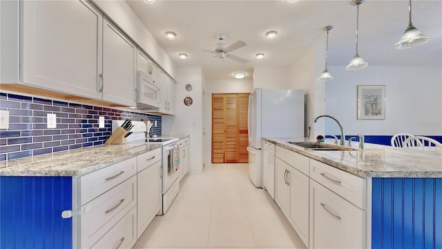 kitchen with backsplash, white cabinets, pendant lighting, and white appliances