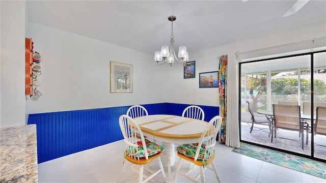 tiled dining area featuring a notable chandelier