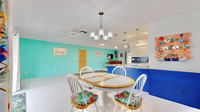 dining room featuring ceiling fan with notable chandelier and light tile patterned flooring