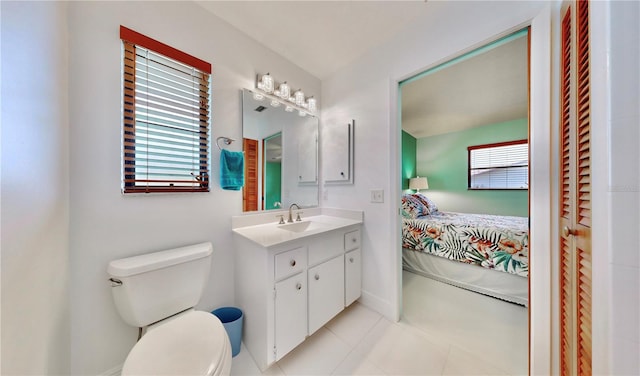 bathroom featuring tile patterned floors, vanity, toilet, and plenty of natural light