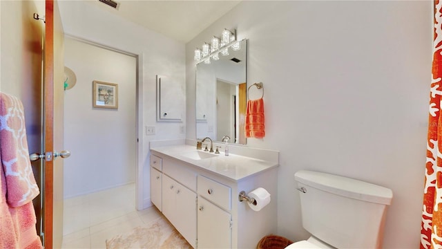 bathroom with tile patterned floors, vanity, and toilet