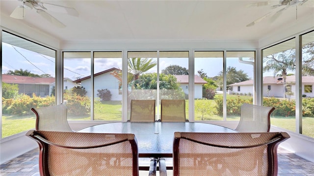 unfurnished sunroom featuring ceiling fan