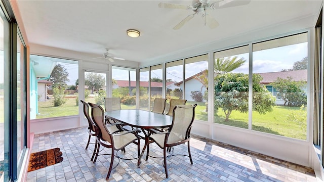 sunroom featuring ceiling fan