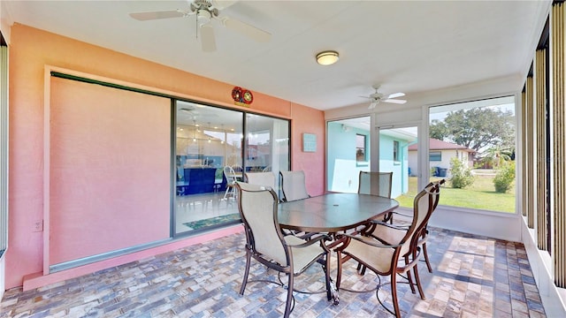 sunroom featuring ceiling fan and plenty of natural light