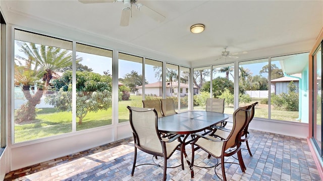 sunroom featuring ceiling fan