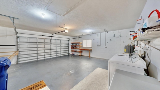 garage with washer and dryer and a garage door opener