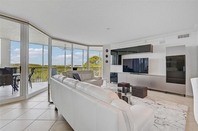 living room featuring floor to ceiling windows, light tile flooring, and a wealth of natural light