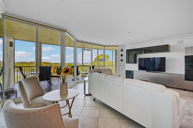 tiled living room featuring floor to ceiling windows