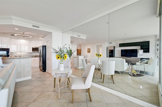 tiled dining area featuring ornamental molding