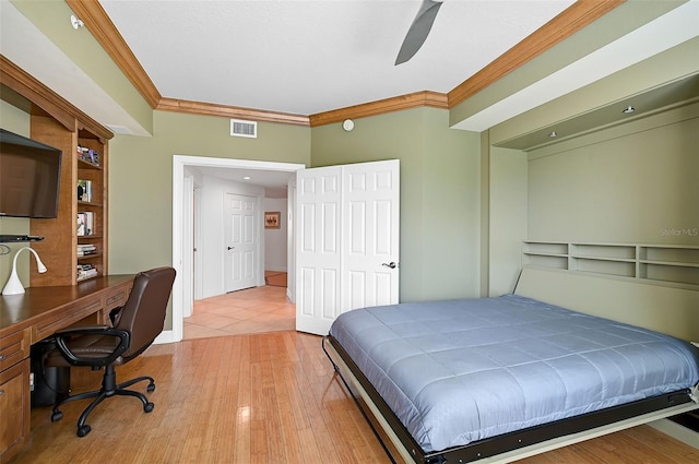 tiled bedroom with ornamental molding and ceiling fan