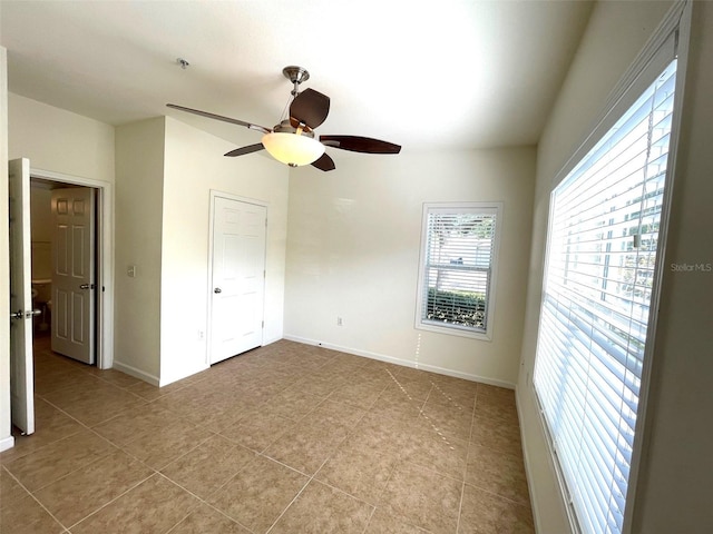 unfurnished bedroom with ceiling fan, a closet, and light tile patterned floors