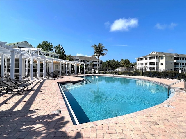 view of pool with a pergola and a patio