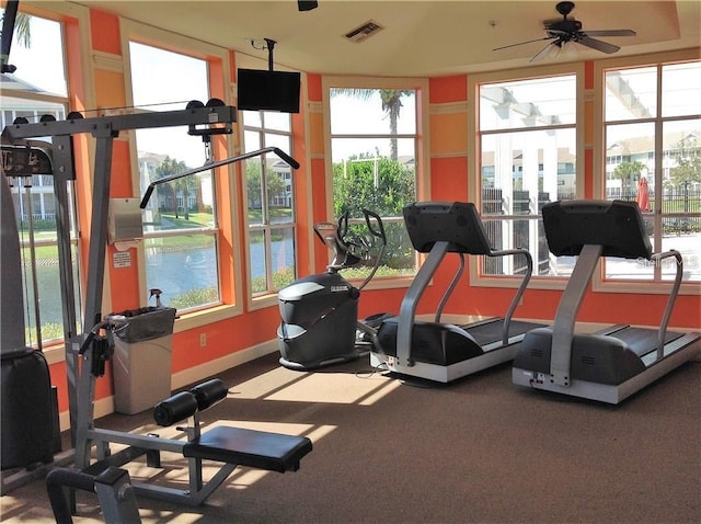 exercise room with ceiling fan and carpet floors