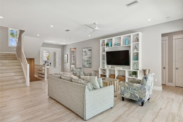 living room with light wood-type flooring and ceiling fan