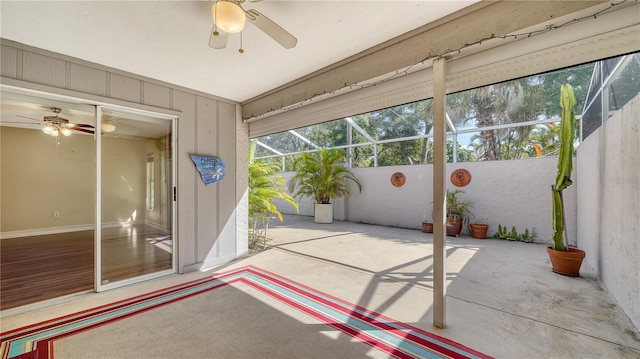 unfurnished sunroom with ceiling fan