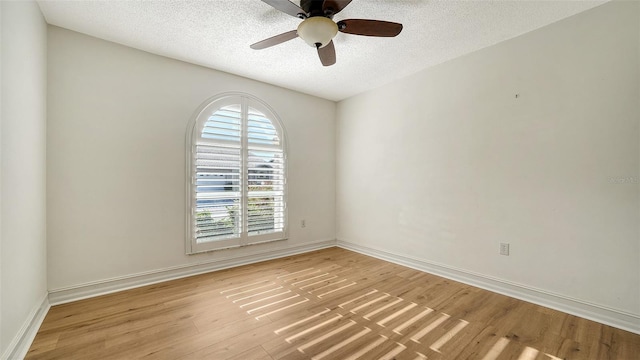 empty room featuring ceiling fan, light hardwood / wood-style floors, and a textured ceiling