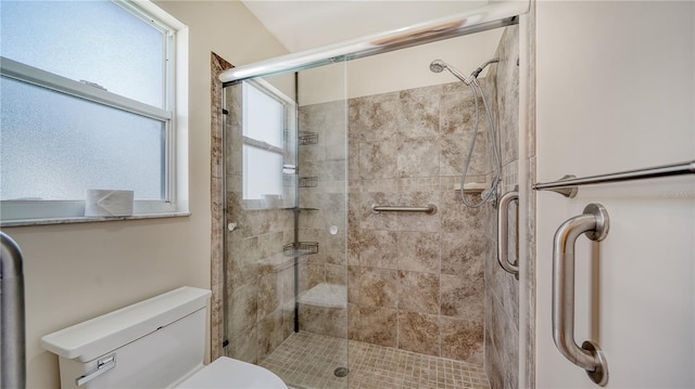 bathroom featuring an enclosed shower and toilet