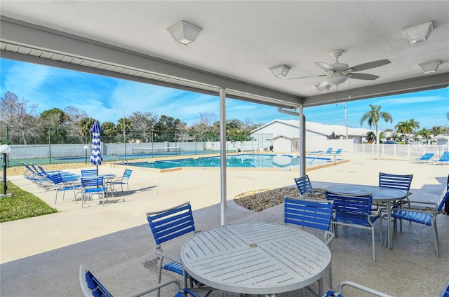 view of patio featuring ceiling fan and a community pool