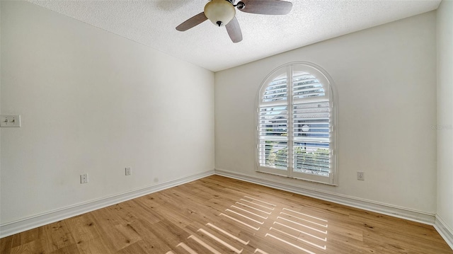 empty room featuring ceiling fan, a textured ceiling, and light hardwood / wood-style flooring