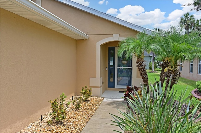 doorway to property featuring a yard