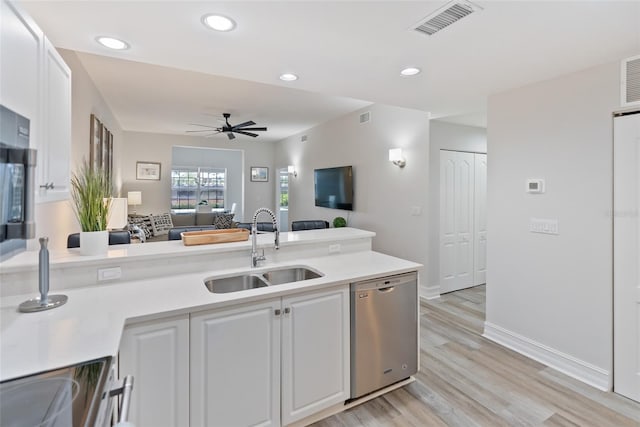 kitchen featuring dishwasher, ceiling fan, sink, white cabinets, and light wood-type flooring