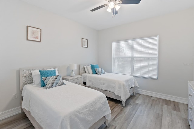 bedroom with light wood-type flooring and ceiling fan