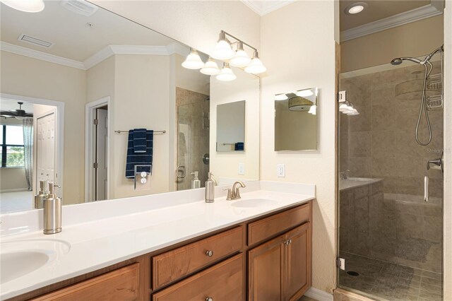 bathroom with walk in shower, ceiling fan, double vanity, and ornamental molding