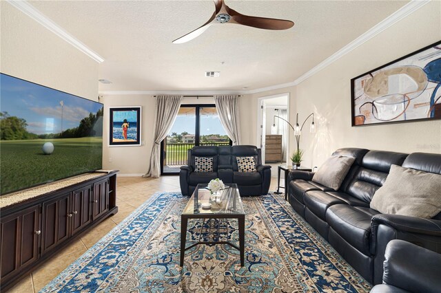 living room with a textured ceiling, ceiling fan, crown molding, and light tile flooring