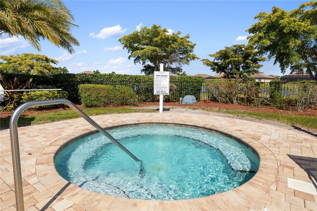 view of pool featuring a hot tub and a patio