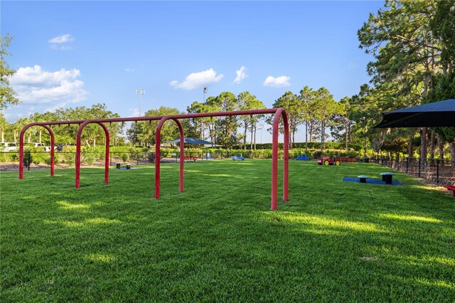 view of property's community with a yard and a playground