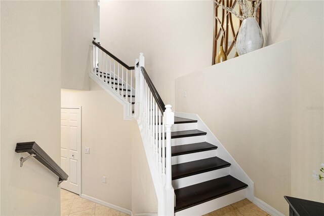 stairs featuring light tile floors