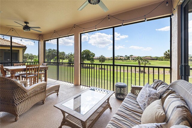 sunroom featuring ceiling fan