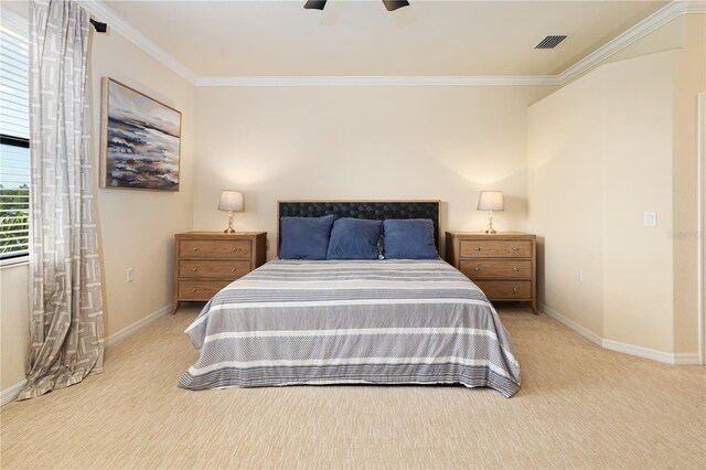 carpeted bedroom featuring ornamental molding and ceiling fan