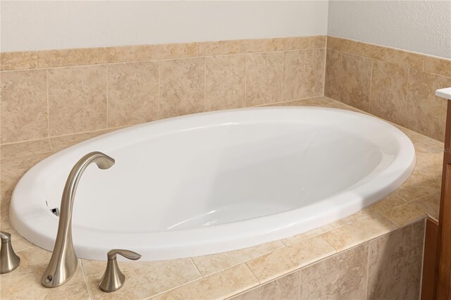 bathroom featuring a relaxing tiled bath