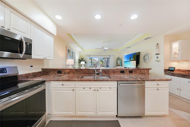 kitchen with white cabinetry, appliances with stainless steel finishes, sink, and ceiling fan