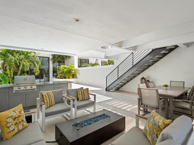 view of patio / terrace featuring an outdoor living space with a fire pit and a grill