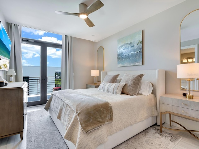 bedroom with access to exterior, expansive windows, and ceiling fan