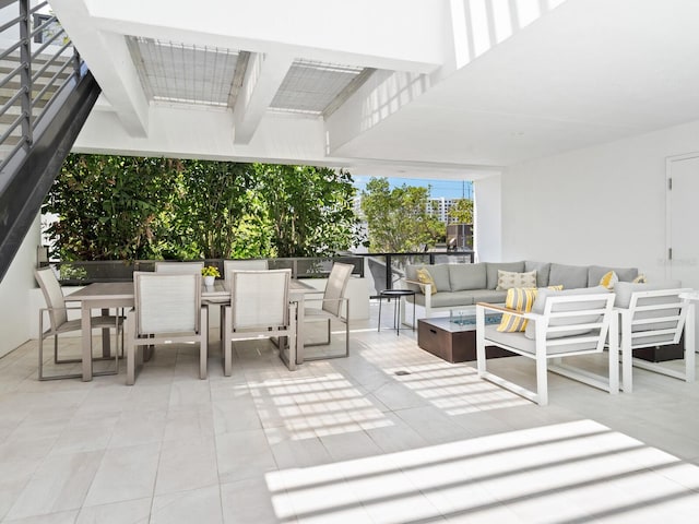 view of patio / terrace with an outdoor living space with a fire pit