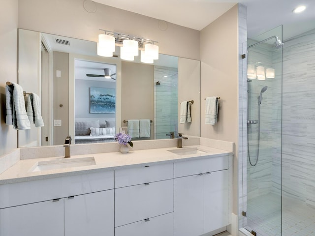 bathroom with vanity, ceiling fan, and walk in shower