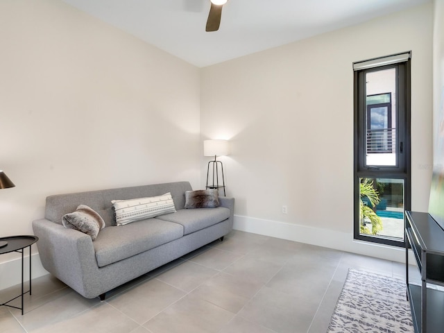 tiled living room featuring ceiling fan