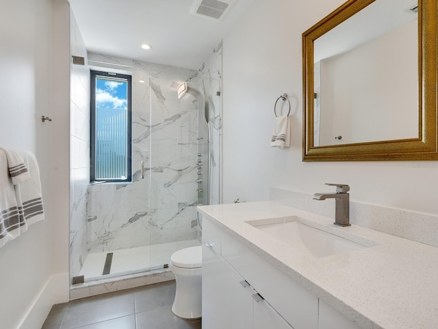 bathroom with tile patterned flooring, vanity, toilet, and a shower with door