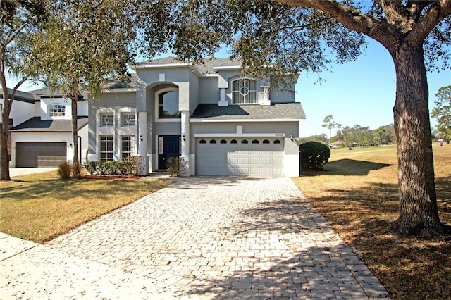 view of front property with a garage and a front lawn