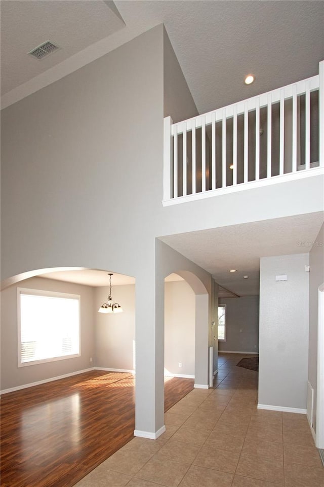 interior space featuring a high ceiling and wood-type flooring