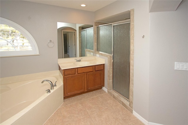 bathroom with shower with separate bathtub, vanity, and tile patterned floors