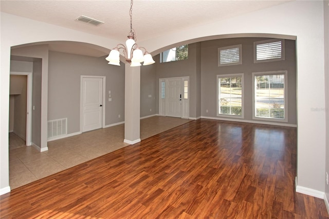 interior space featuring hardwood / wood-style flooring, a chandelier, a textured ceiling, and a wealth of natural light