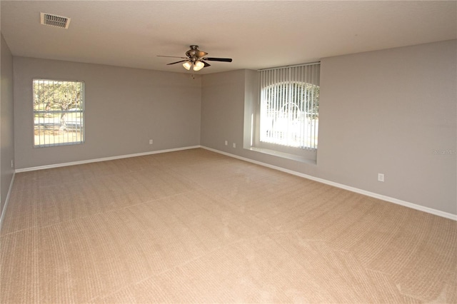 unfurnished room featuring light colored carpet and ceiling fan