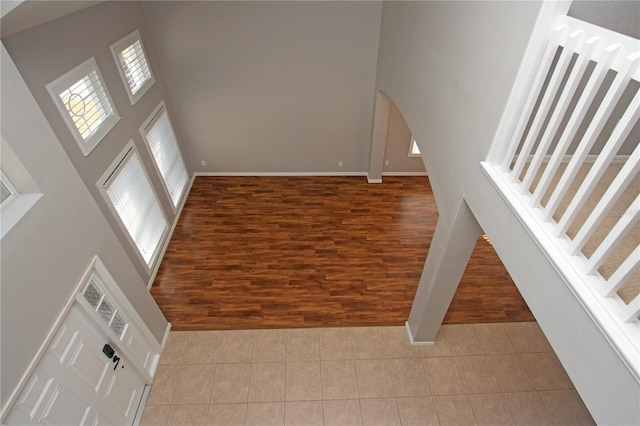 entryway featuring a high ceiling and hardwood / wood-style floors