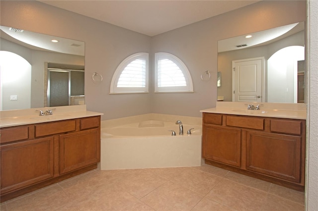 bathroom featuring tile patterned floors, vanity, and plus walk in shower